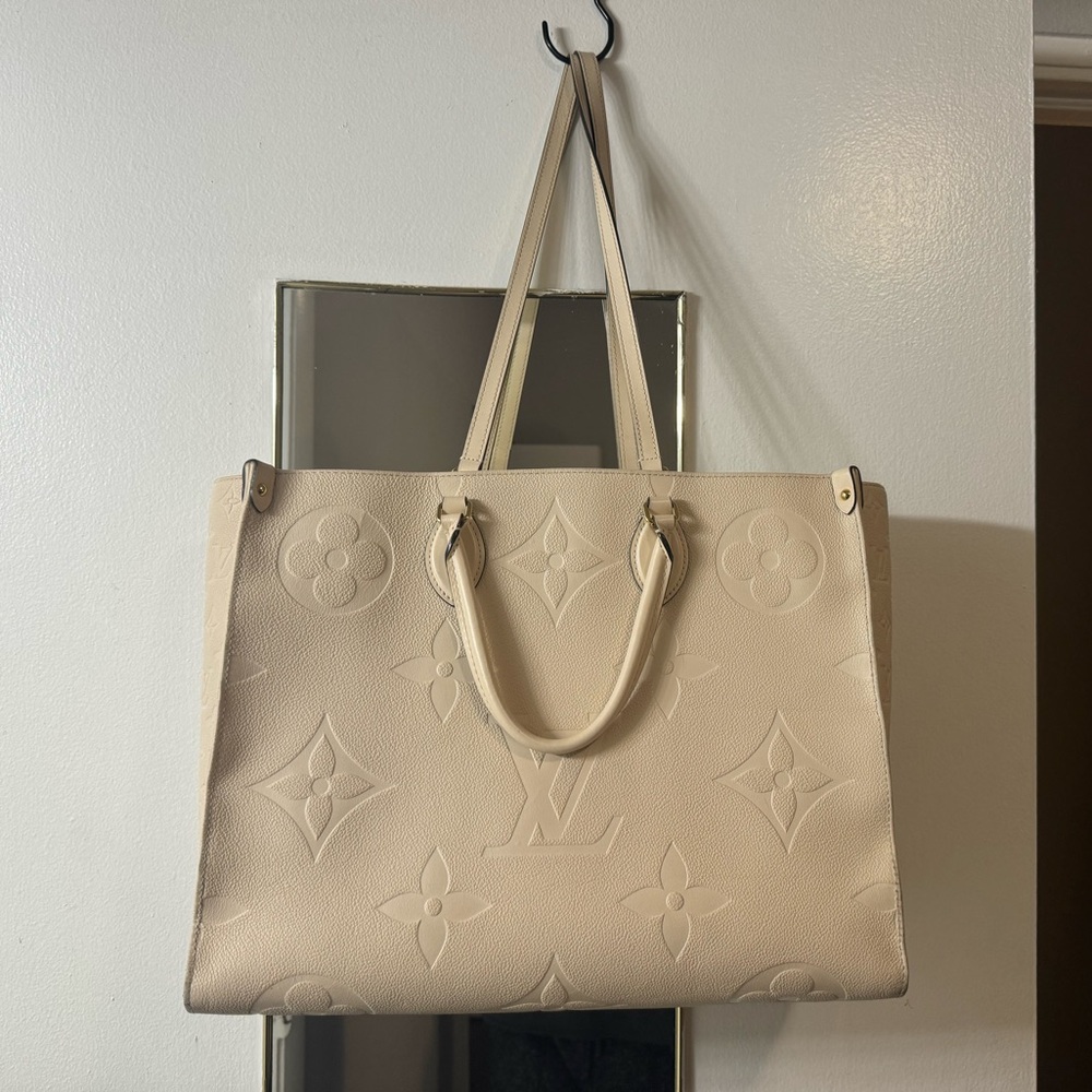 Authentic Louis Vuitton Crème Monogram Empreinte OnTheGo